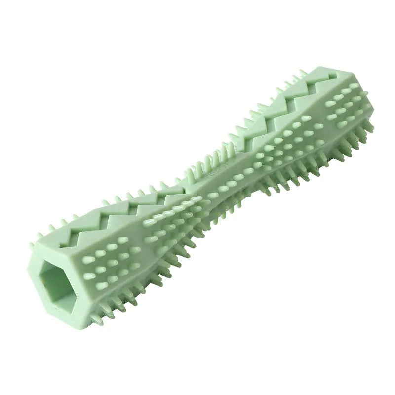 A green rubber doggie dental stick with textured bristles and ridges for cleaning teeth and massaging gums.