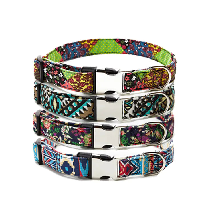 Stack of colorful patterned dog collars with metal buckles on a white background