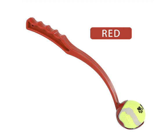 Red (Ruby) colored doggie ball launcher toy with a curved handle and a tennis ball attached to the end.