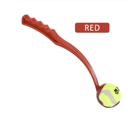 Red (Ruby) colored doggie ball launcher toy with a curved handle and a tennis ball attached to the end.