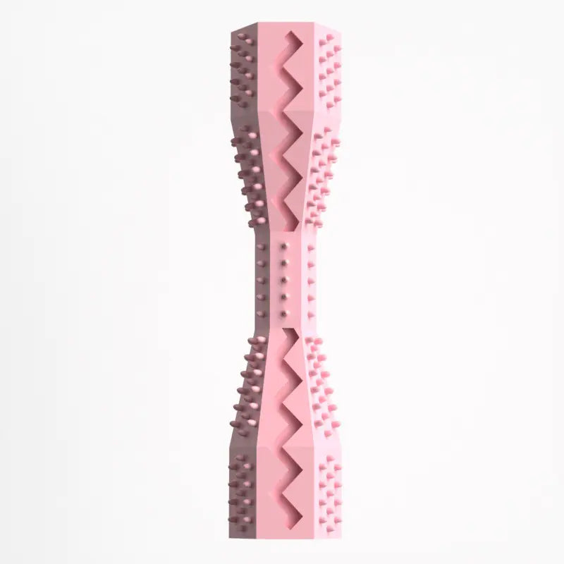 A pink rubber doggie dental stick with textured bristles and ridges for cleaning teeth and massaging gums.