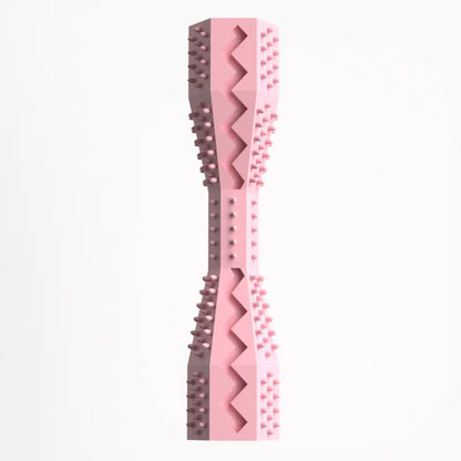 A pink rubber doggie dental stick with textured bristles and ridges for cleaning teeth and massaging gums.