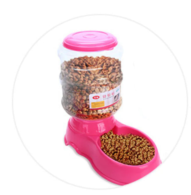 Pink (Bubblegum) gravity fed food dispenser. Filled with food, providing food access for your doggy throughout the day.