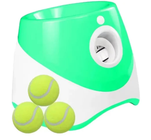 Green and white tennis ball launcher with three yellow tennis balls for puppy play time