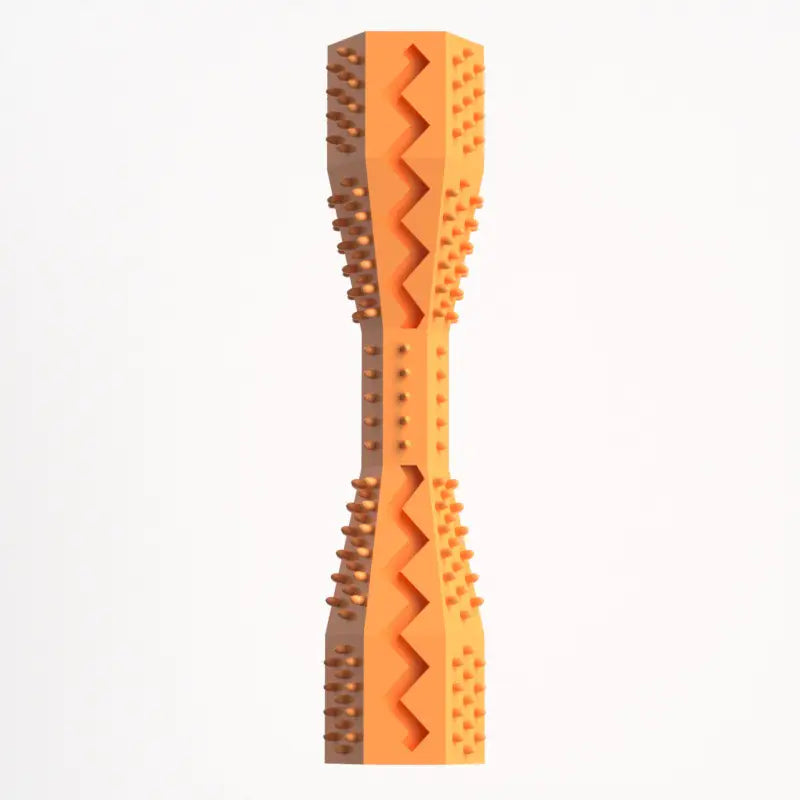 A orange rubber doggie dental stick with textured bristles and ridges for cleaning teeth and massaging gums.