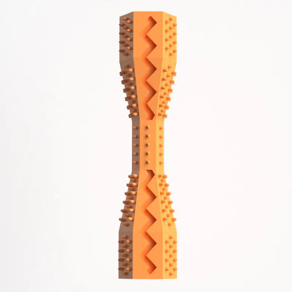 A orange rubber doggie dental stick with textured bristles and ridges for cleaning teeth and massaging gums.
