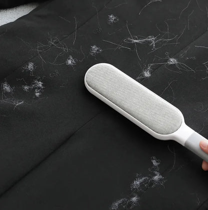Gray Electrostatic Hair Removal Brush removing pet hair from black fabric
