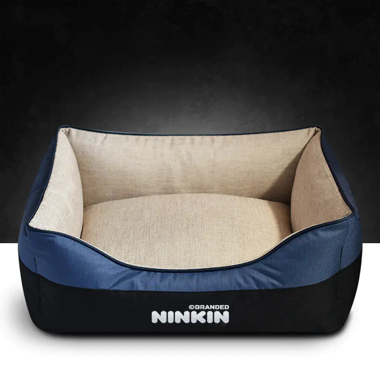A blue and beige removable washable doggie bed with a non-slip bottom and plush interior, branded with the name NINKIN.