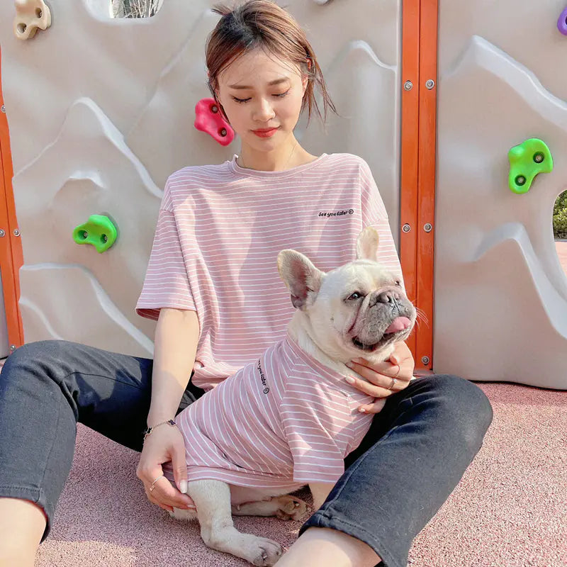 Pet parent and doggie wearing matching Pink (Rose) striped shirts. Twinning with your pup makes your walks twice as nice.