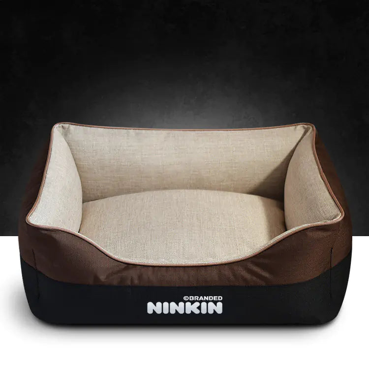 A brown and beige removable washable dog bed with a non-slip bottom and plush interior, branded with the name NINKIN.