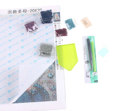 Diamond painting kit with materials and tools on a white background