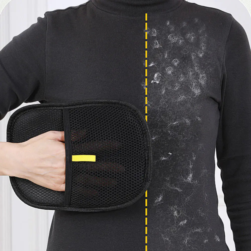 Person using black pet grooming glove to clean a soiled shirt