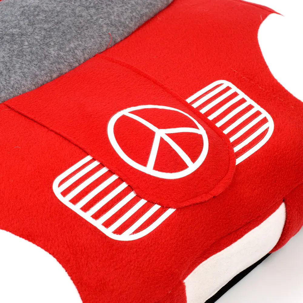 Close up of Mercedes Benz emblem on luxury themed red and gray car-shaped pet bed.
