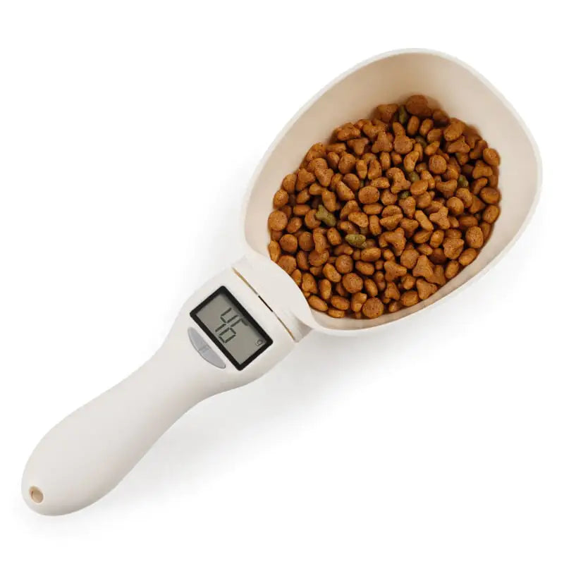A White (Pearl) electronic pet food weighing spoon filled with dry kibble, featuring a digital LCD screen on the handle.