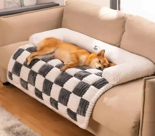 Doggy sleeping on a gray and white checkered pet sofa cover on a beige couch.