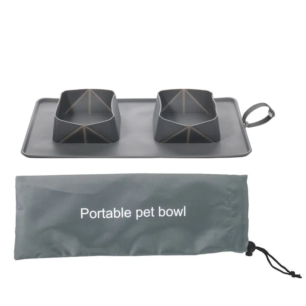 Portable pet bowl made of silicone, displayed with its carrying bag. Bowl and bag have a Gray (Mist) color.