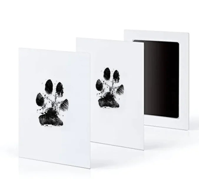 Commemorative photo album with two pages showing paw prints that were captured for special memories with their cherished doggy