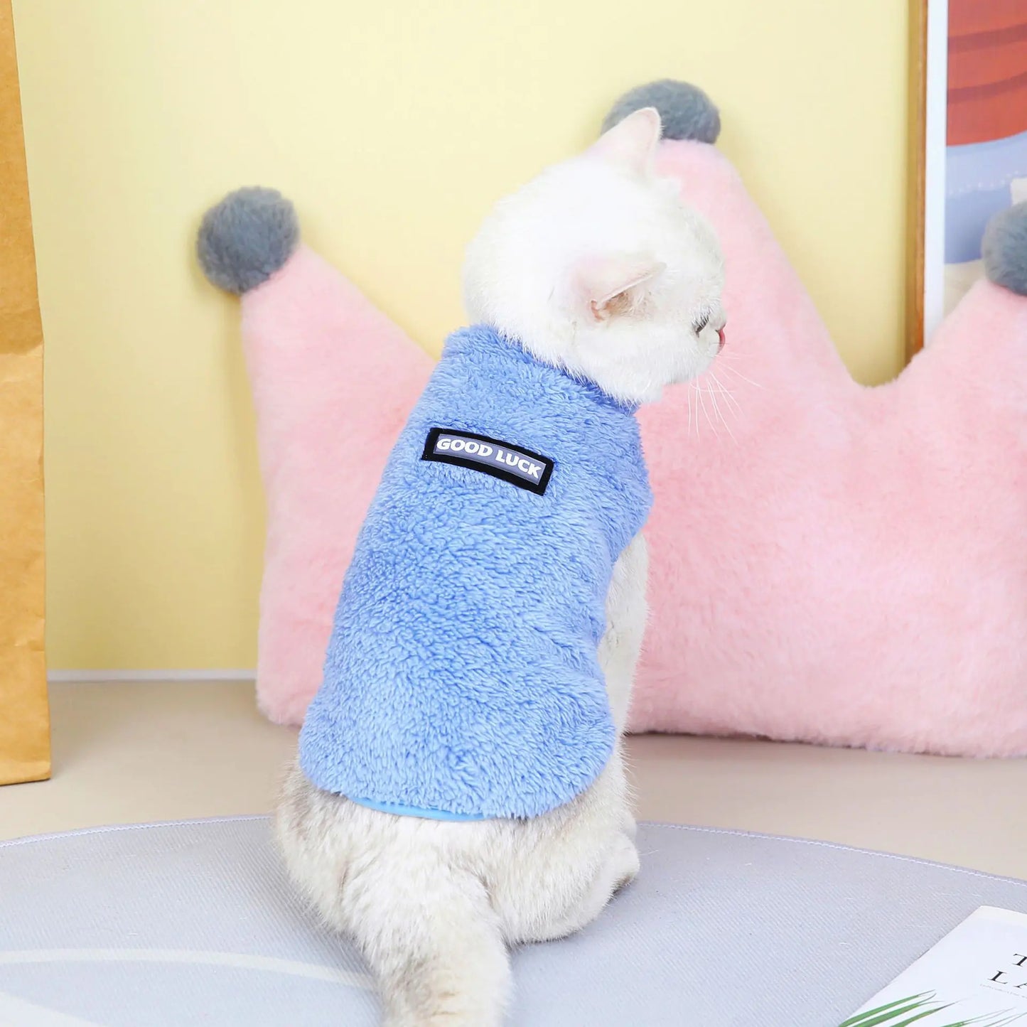 Pet wearing a blue fleece jacket. A snug fit and soft lining ensure your dog stays comfortable on every morning walk.