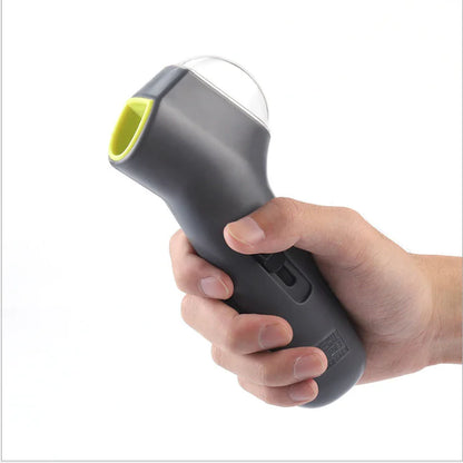 Gray (Mist) colored pet treat launcher being held by the dog owner and preparing to launch tasty dog treats.