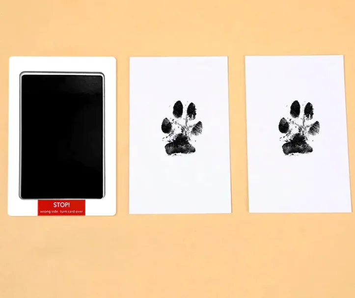 Commemorative photo album with two pages showing paw prints that were captured for special memories with their cherished pet