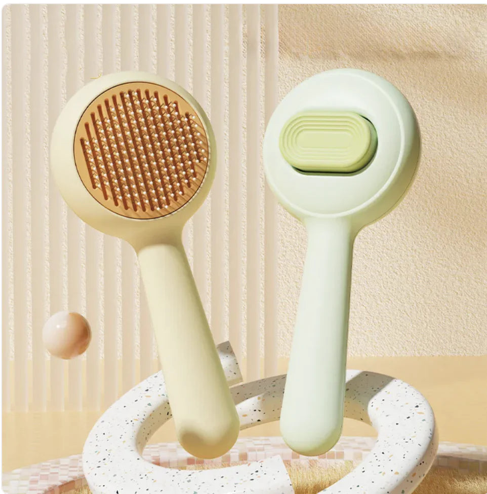 Green and yellow skin-friendly dog brushes with steel combs used for detangling pet fur and removing loose hair.