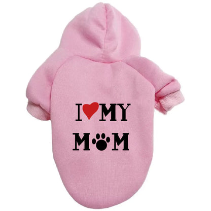 Pink pet hoodie with ‘I ❤️ MY MOM’ print on a white background. Made of soft polyester for your dog's warmth and comfort.