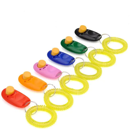 Six of the dog clicker training tools in various colors, with a key ring and yellow strap, featuring a raised button for easy clicking.