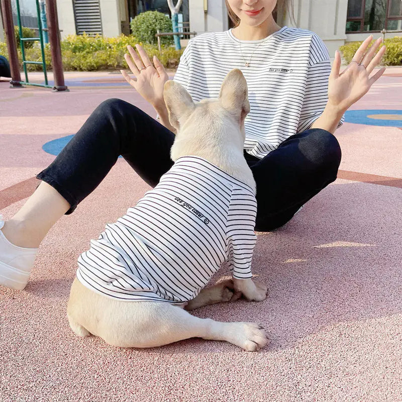Pet parent and doggy wearing matching White (Pearl) and blue striped shirts. Twinning with your pup makes your walks twice as nice.