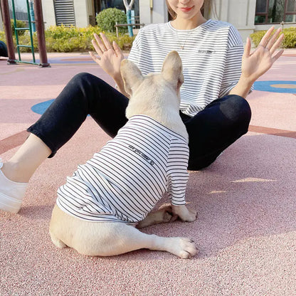 Pet parent and doggy wearing matching White (Pearl) and blue striped shirts. Twinning with your pup makes your walks twice as nice.