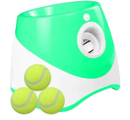 Green and white tennis ball launcher with three yellow tennis balls for puppy play time
